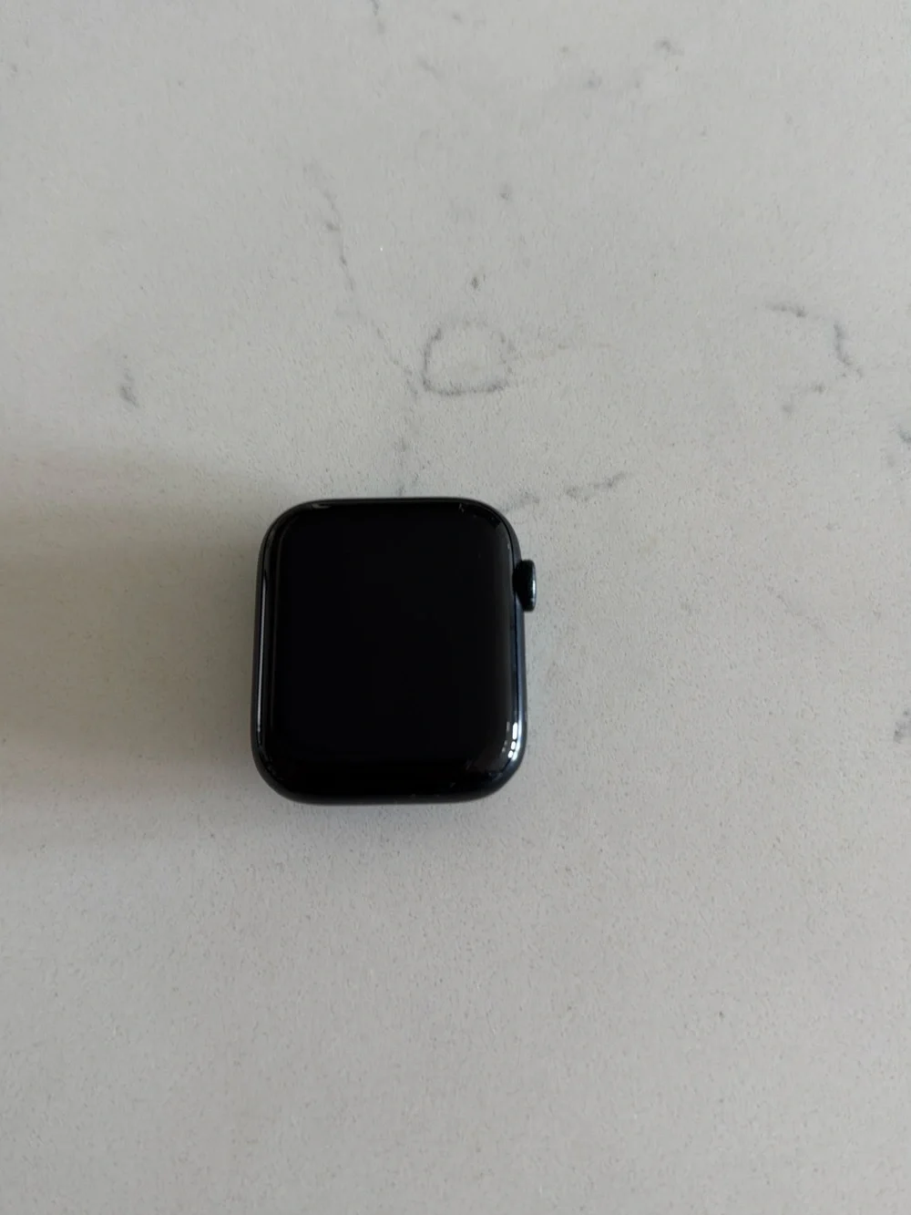 Apple Watch in Black with White Charger Cable
